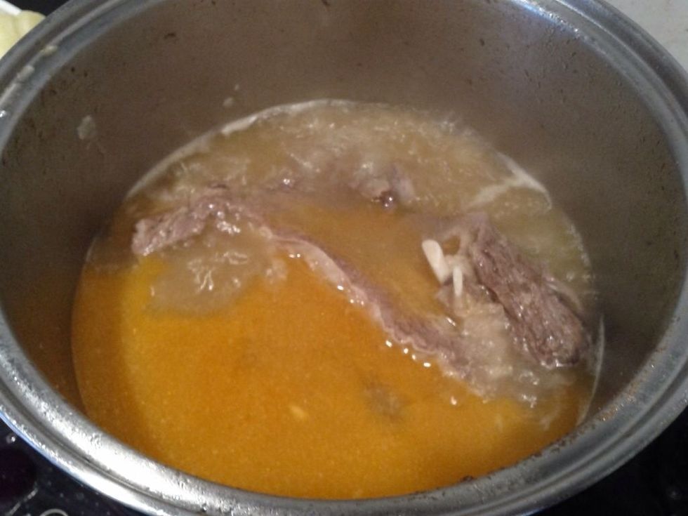 Continue to simmer the meat and potatoes in the pot.