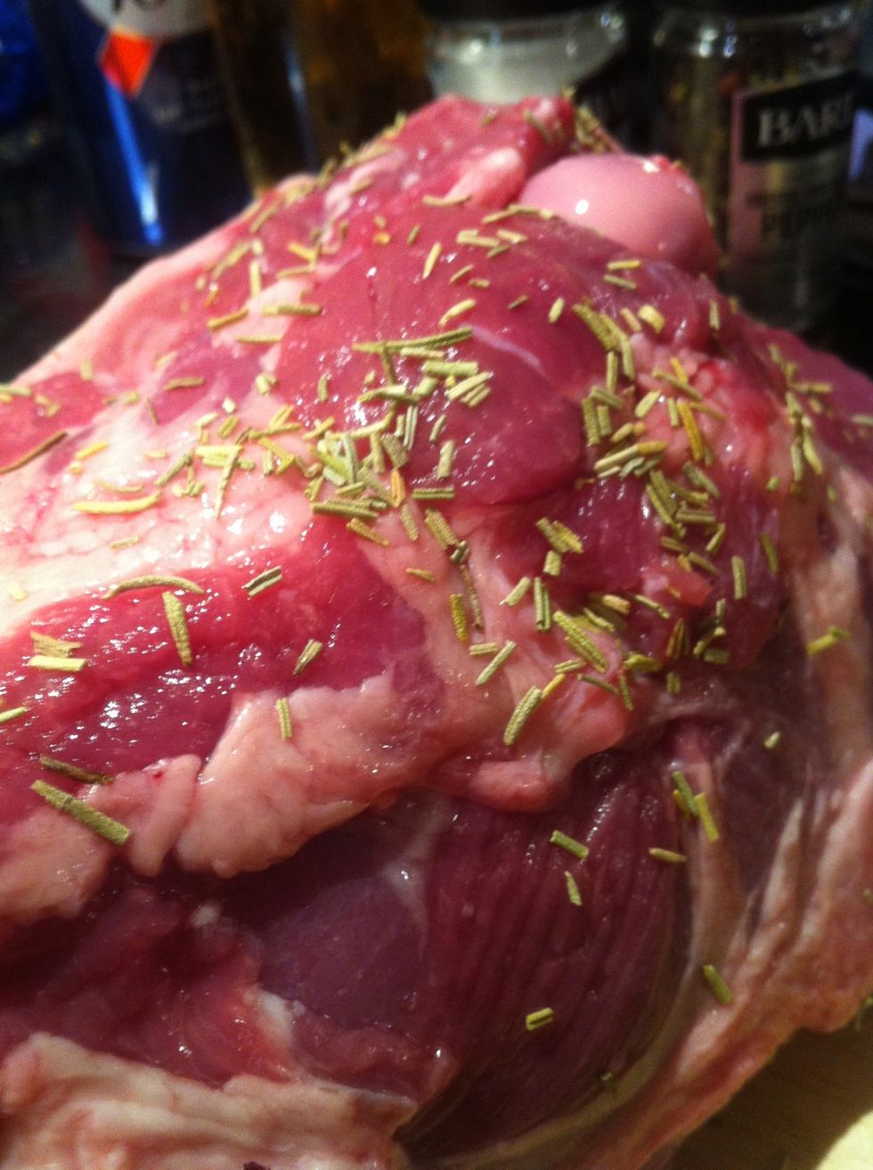 Continue to spice the leg with fresh thyme and oregano