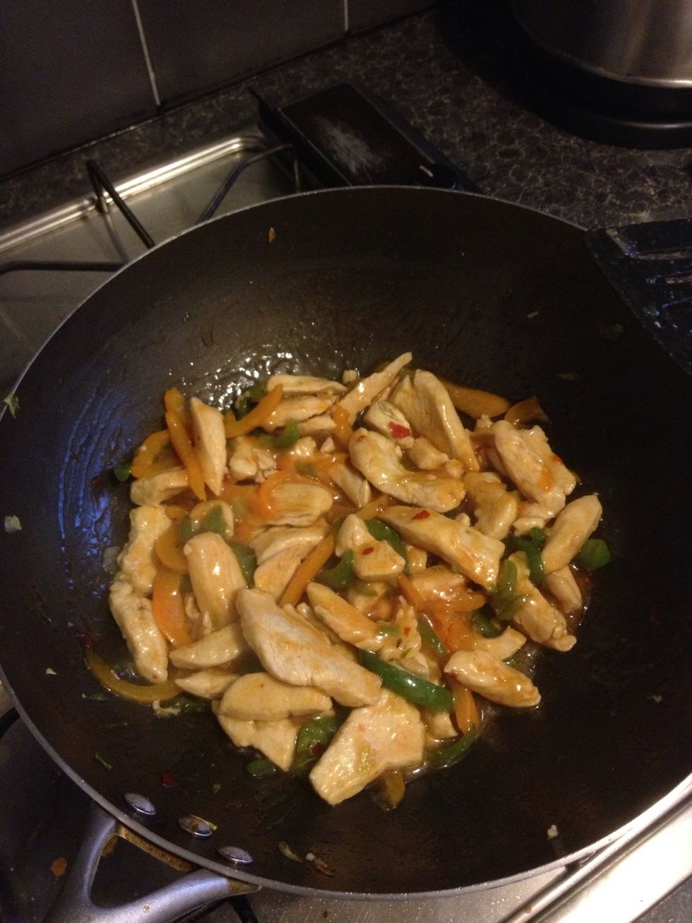 Continue to stir fry the ingredients with the sachet of sauce now added to the pan