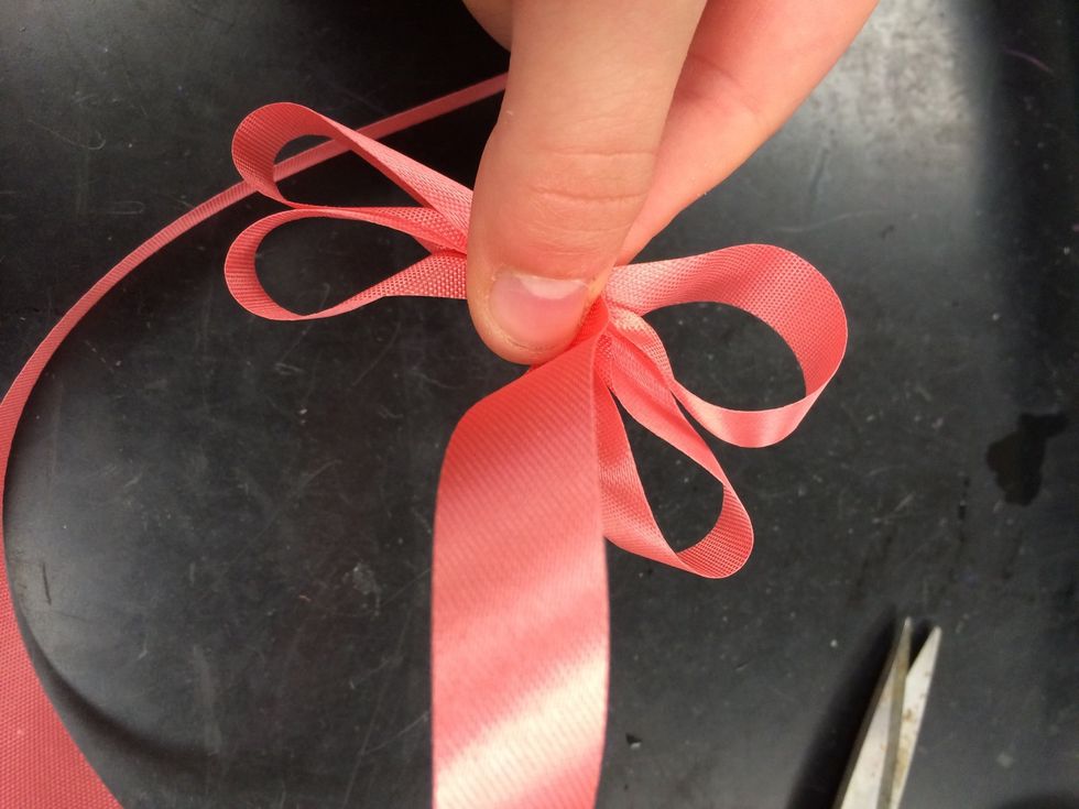 continue to twist the ribbon and make loops on both sides. remember to pinch the center.