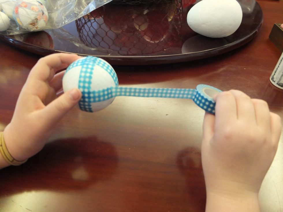 Continue to wrap the ball with tape until it is completely covered.