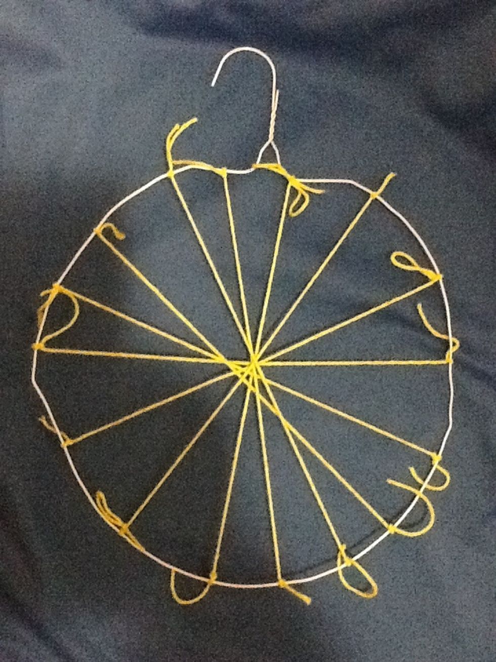 Continue tying yarn until you have 16 segments (think pieces of pie). These strings are called the warp.