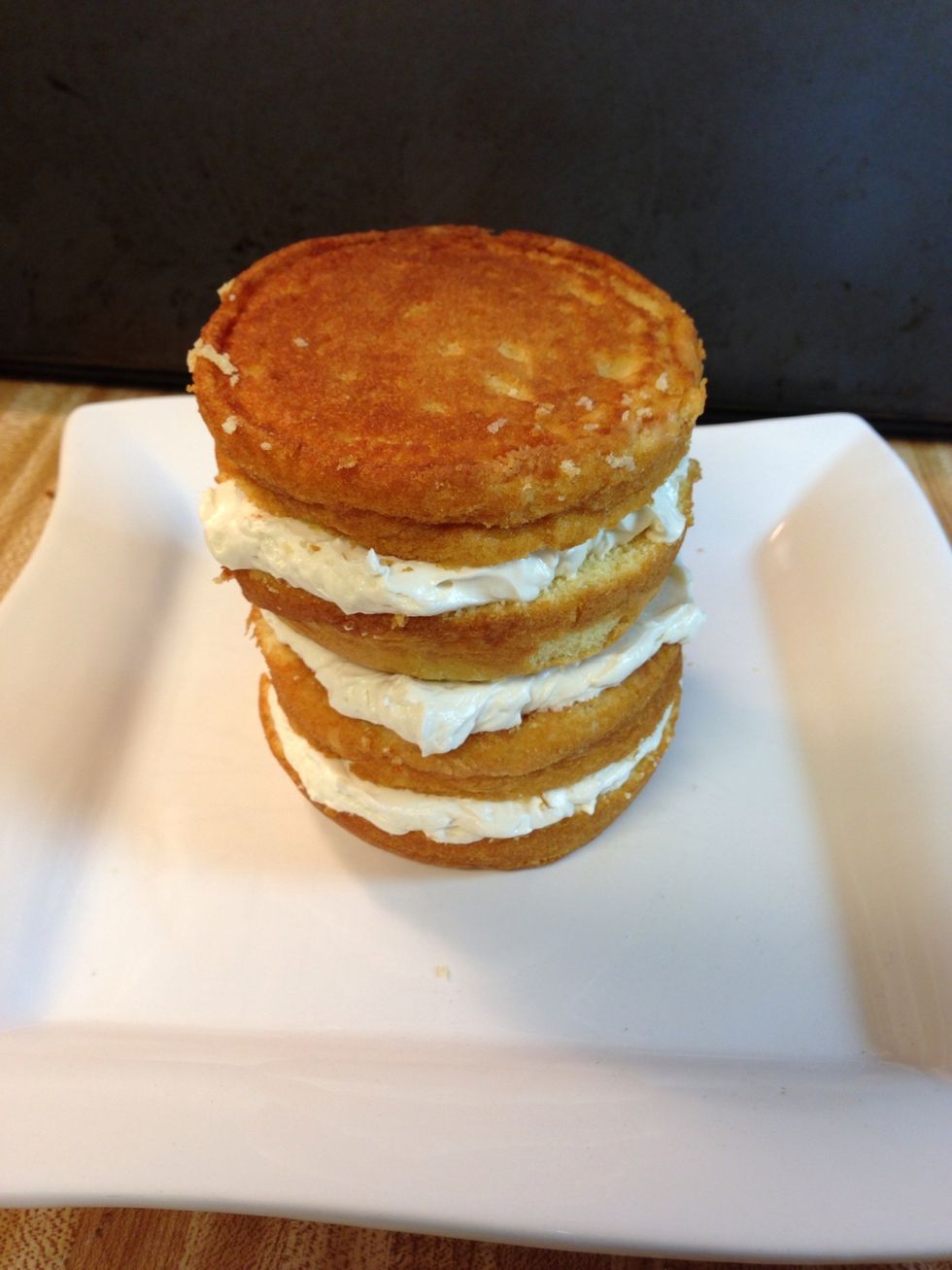 Continue until all layers are complete. Put it in the freezer for a few minutes. This hardens the frosting some so that the layers don't slide around in the next step.