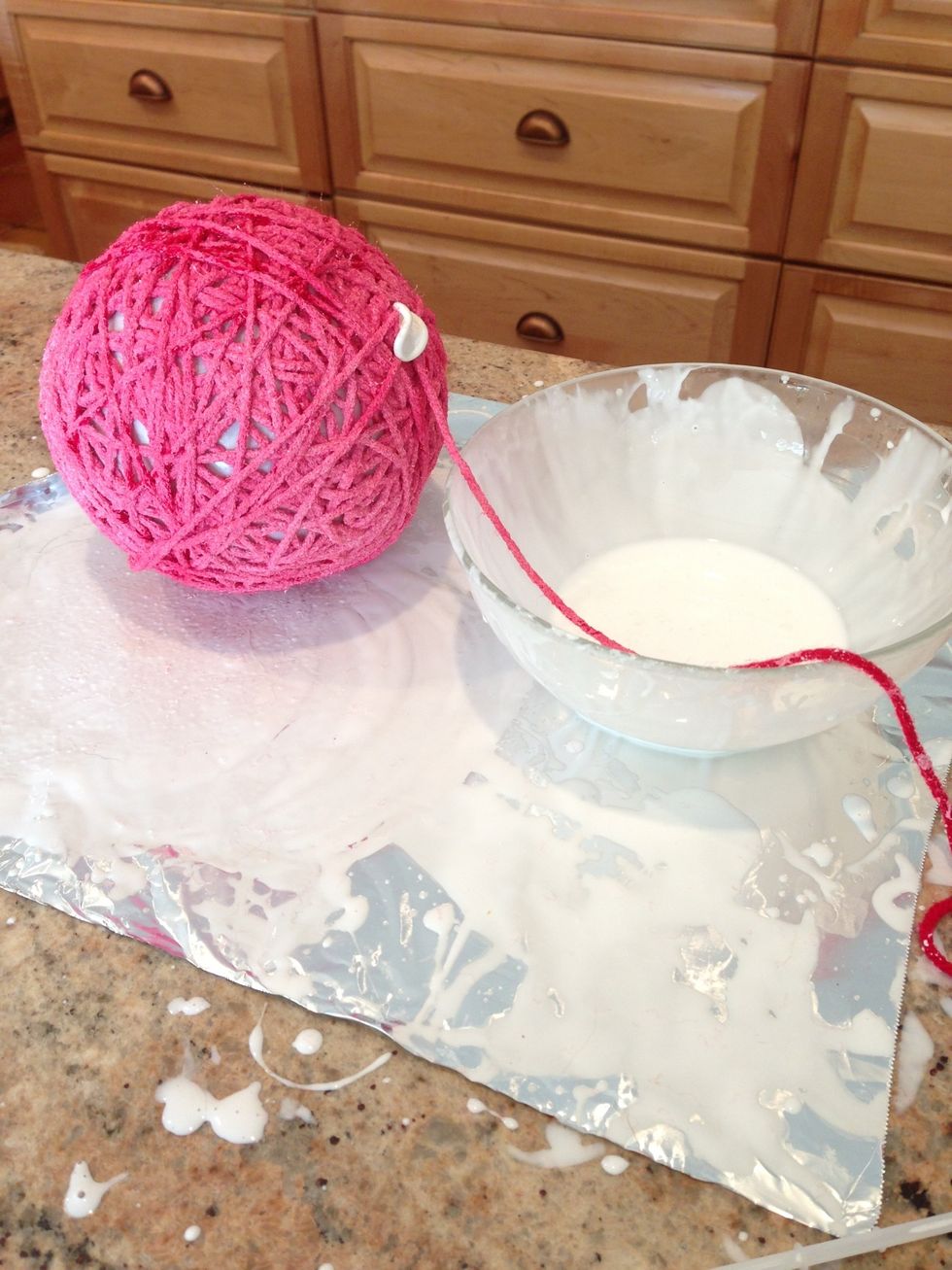 Continue until balloon is mostly covered by yarn