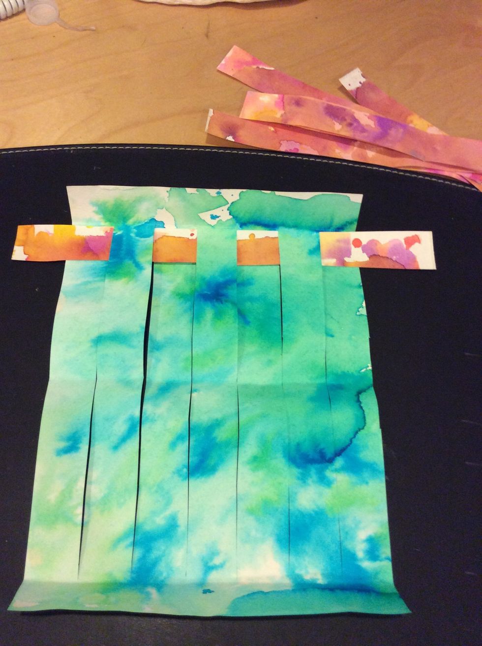 Continue until entire strip is woven. Repeat with remaining 4 warm color strips.