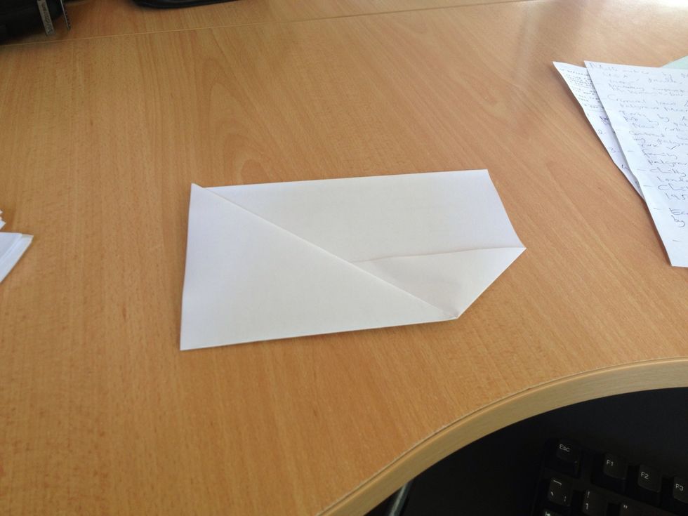 Continue with the triangular part by folding it towards the rectangular side