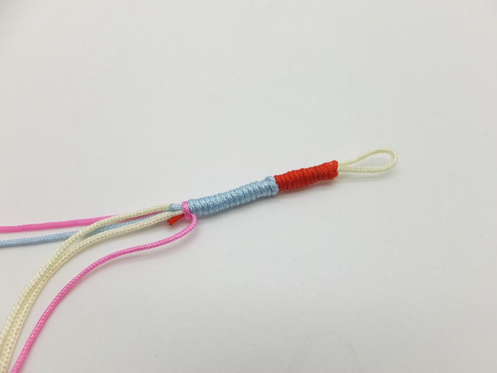 Continue wrapping the sky blue cord.