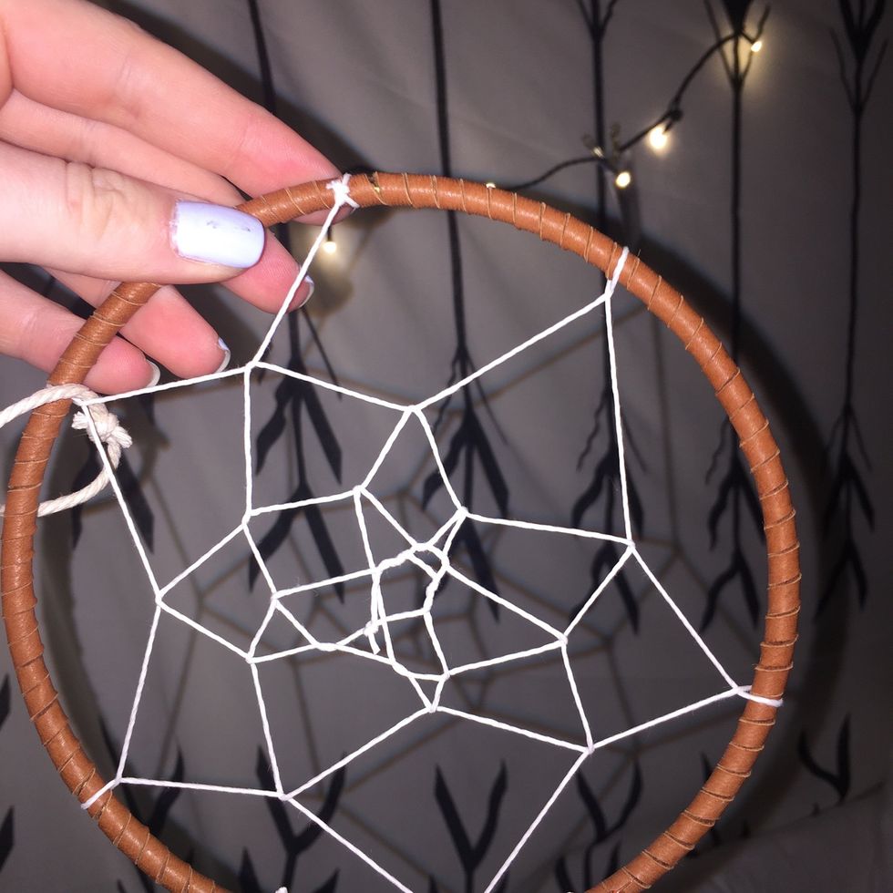 Continue wrapping the string through the loops you have made until you get to the center. Tie the sting off when you get to the center.