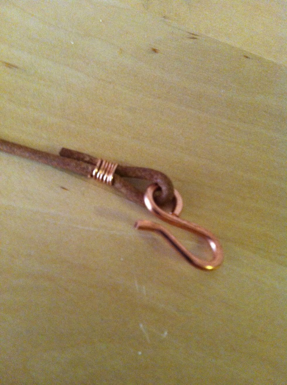 Continue wrapping with the opposite wire until both ends are wrapped tightly around the leather.