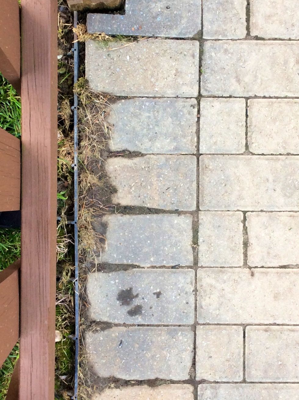 (Continued on) shows that the rain eroded the grass which then pushed the dirt and soil to erode onto the cement.