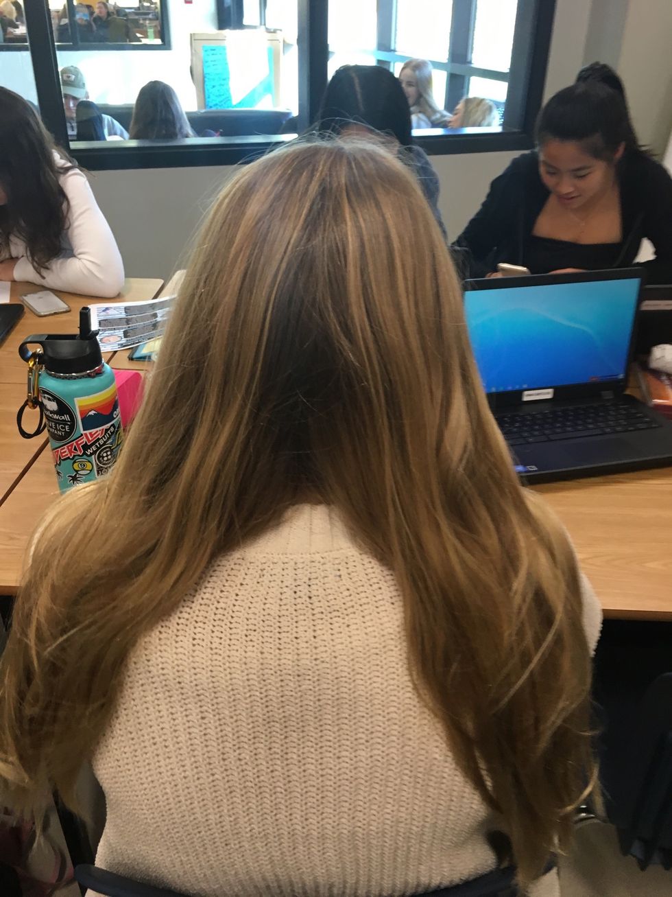 Continuing on from brushing your hair, split your hair in half and separate both pieces so the left side is placed directly on the left shoulder and so that the right side is placed on the right.