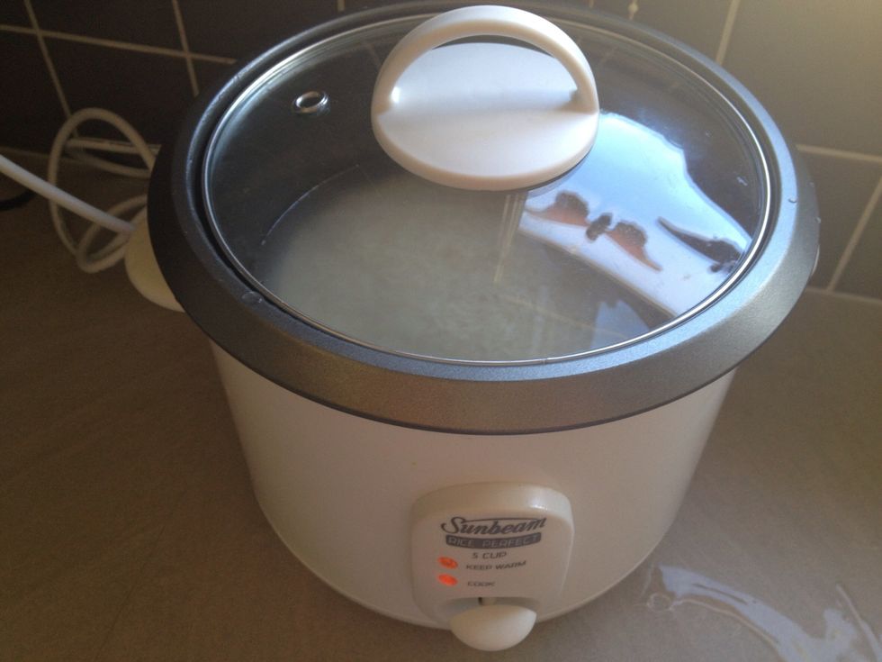 Cook 2 cups of rice. Turn off at the wall, remove lid and let stand till ready to use.