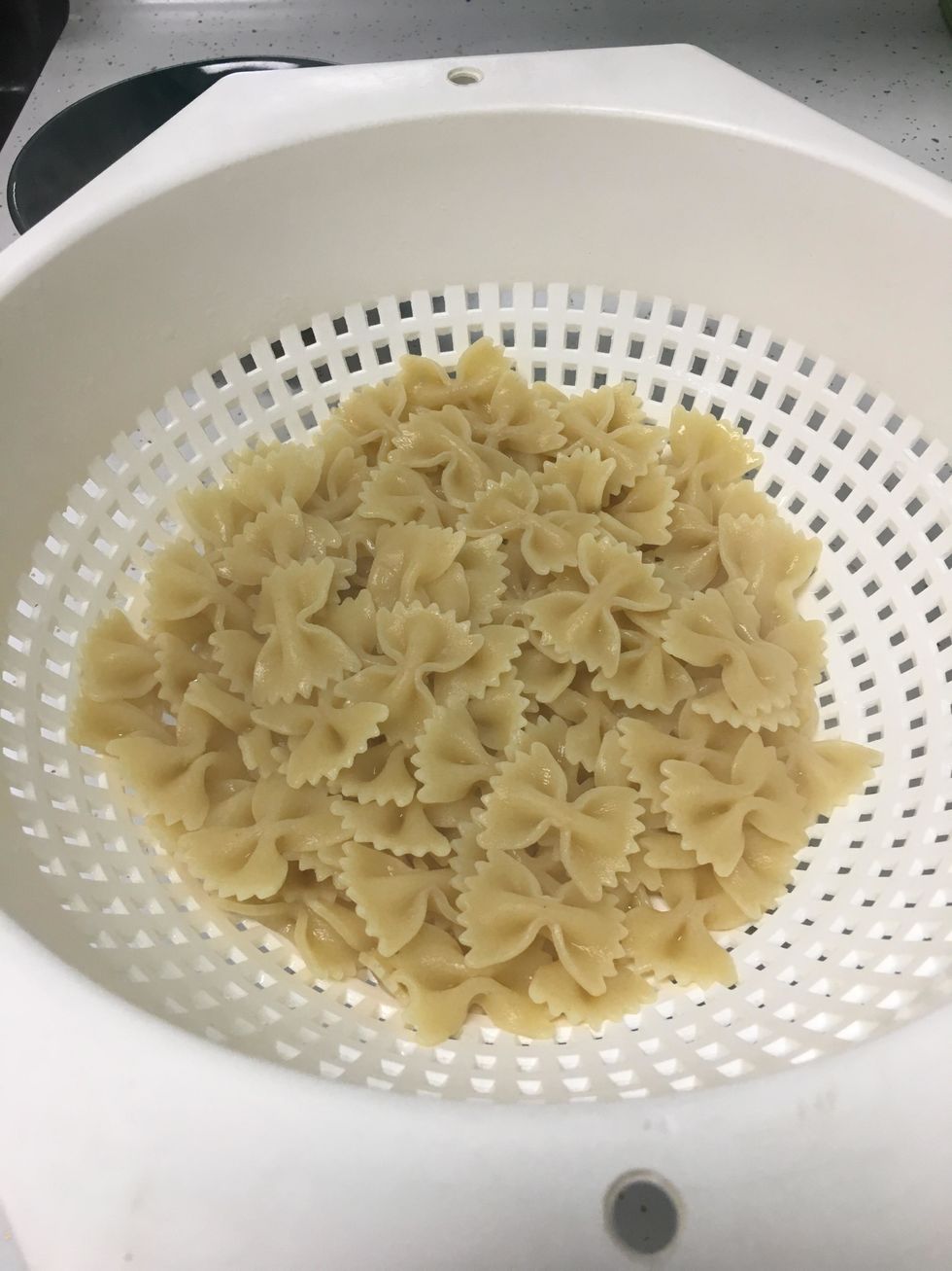 Cook and drain the bowtie pasta then add it into the pot with the other ingredients.