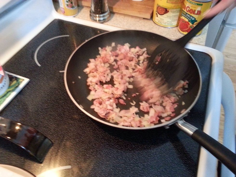 Cook bacon over medium heat, adding onions near the end to soften them.  Set aside for later.