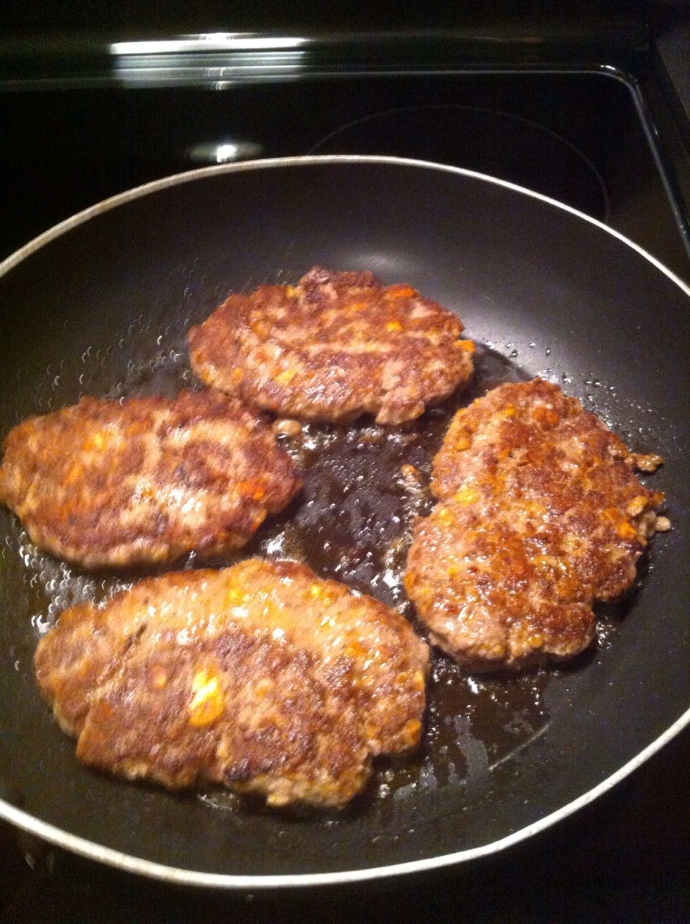 Cook burgers till done.