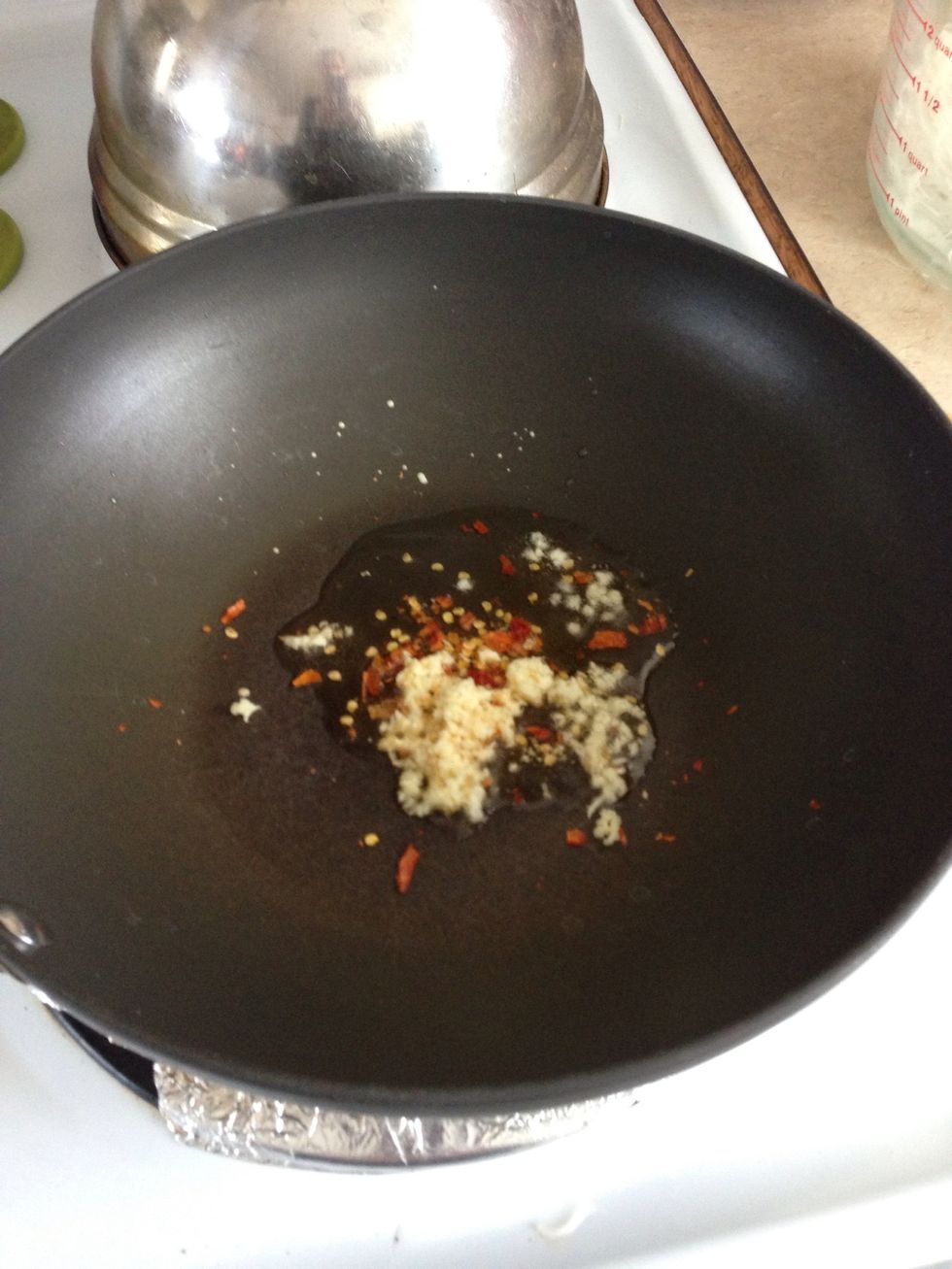 Cook chili and garlic in hot oil, ensuring garlic doesn't burn.