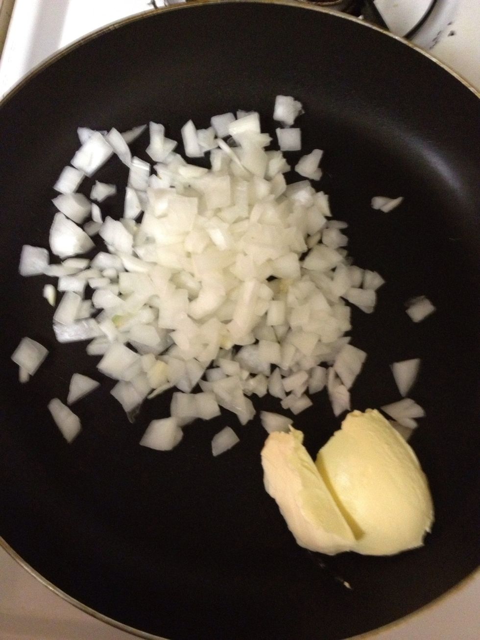 Cook chopped onions in skillet with 2 tablespoons of butter until soft.