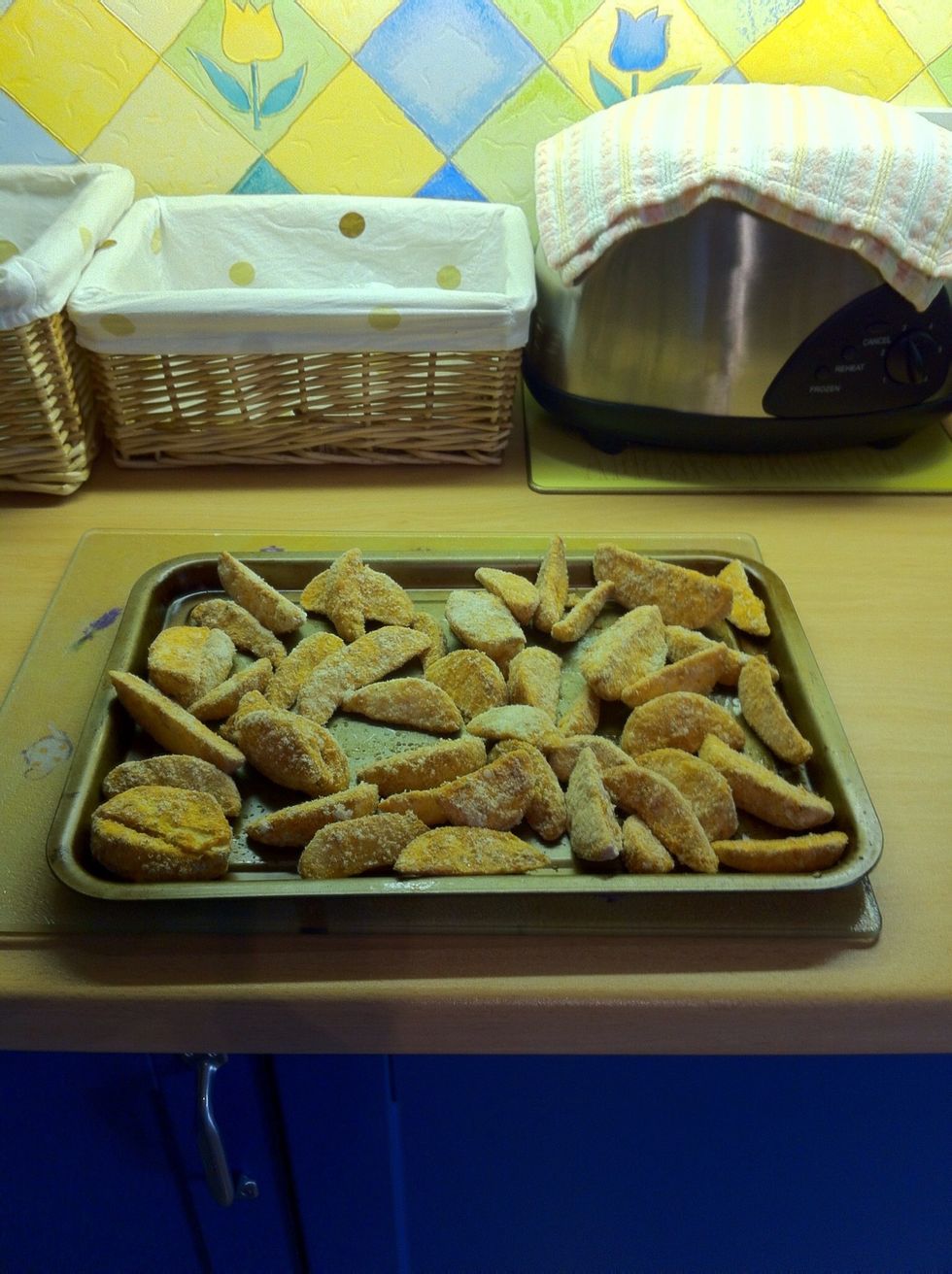 Cook frozen potato wedges in the oven.