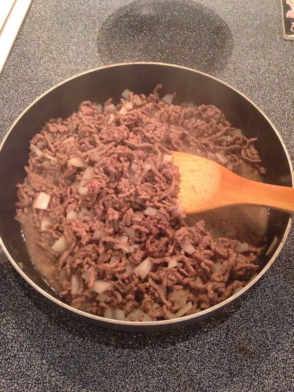 Cook ground beef over medium heat and add onions. When onions are transparent, drain grease.