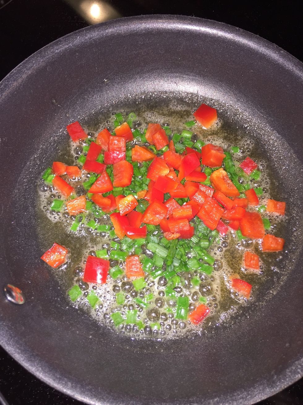 Cook onions and pepper until tender