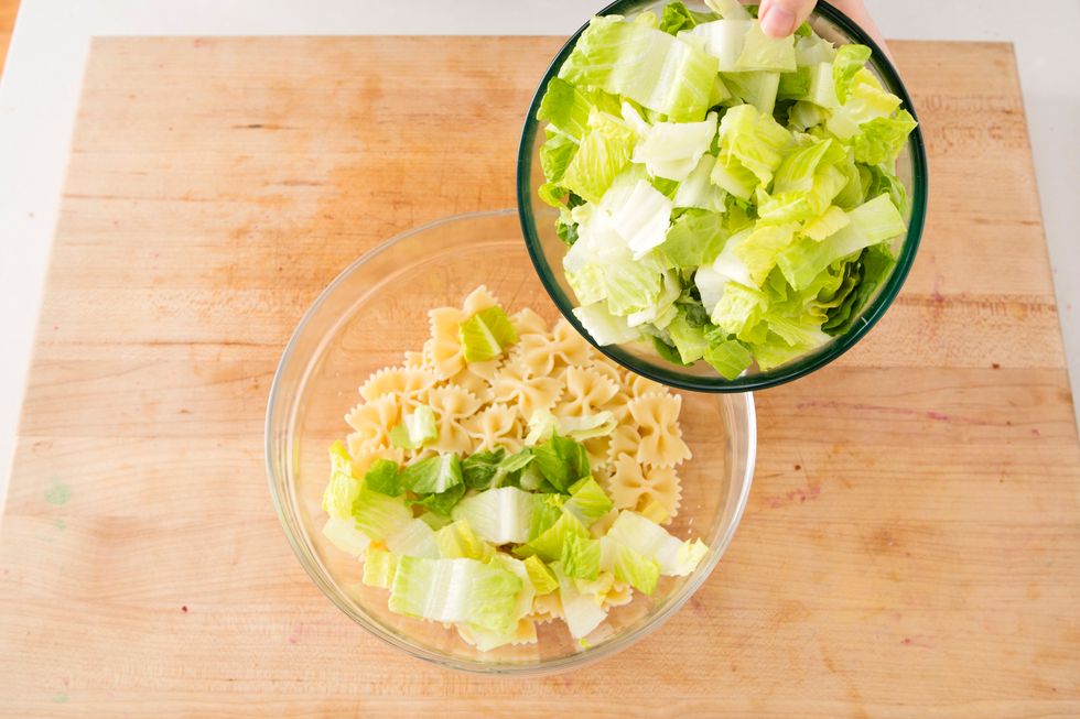 Cook pasta according to the directions. Then in a large bowl, add the romaine lettuce.