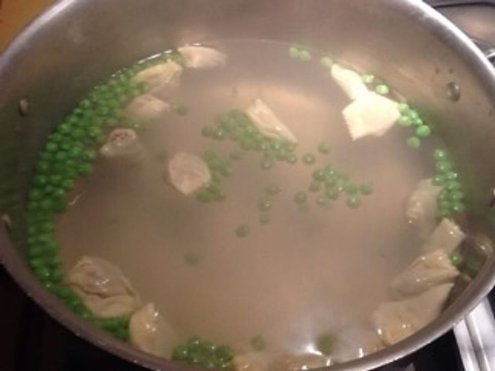 Cook pasta in salted water add peas for last minute or so