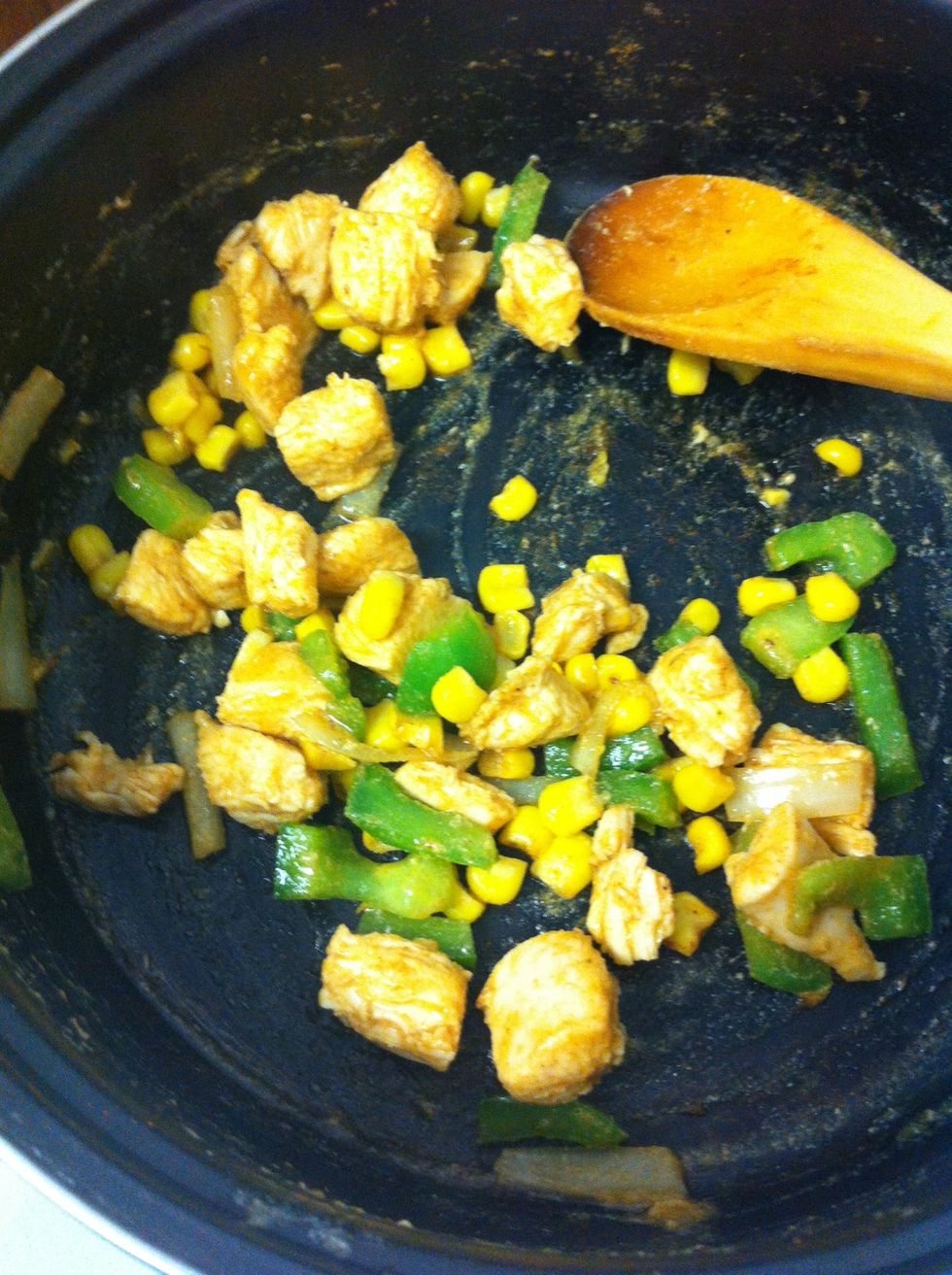 Cook rice and in the meantime, brown chicken. Next, add sliced peppers, onion and corn. Season with taco seasoning.