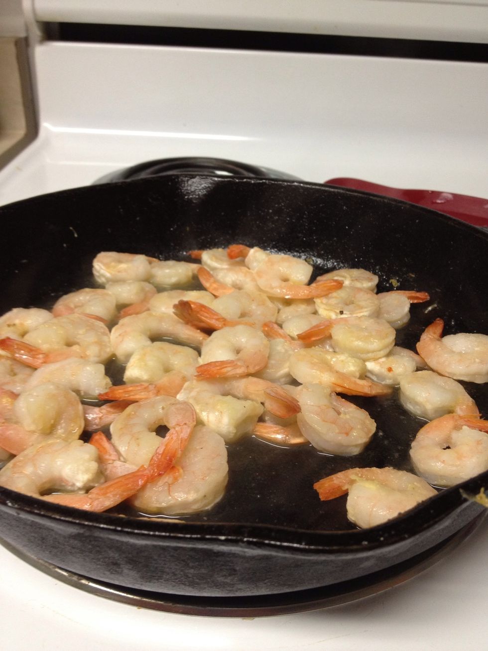 Cook shrimp in butter and put a lid on to steam over medium heat