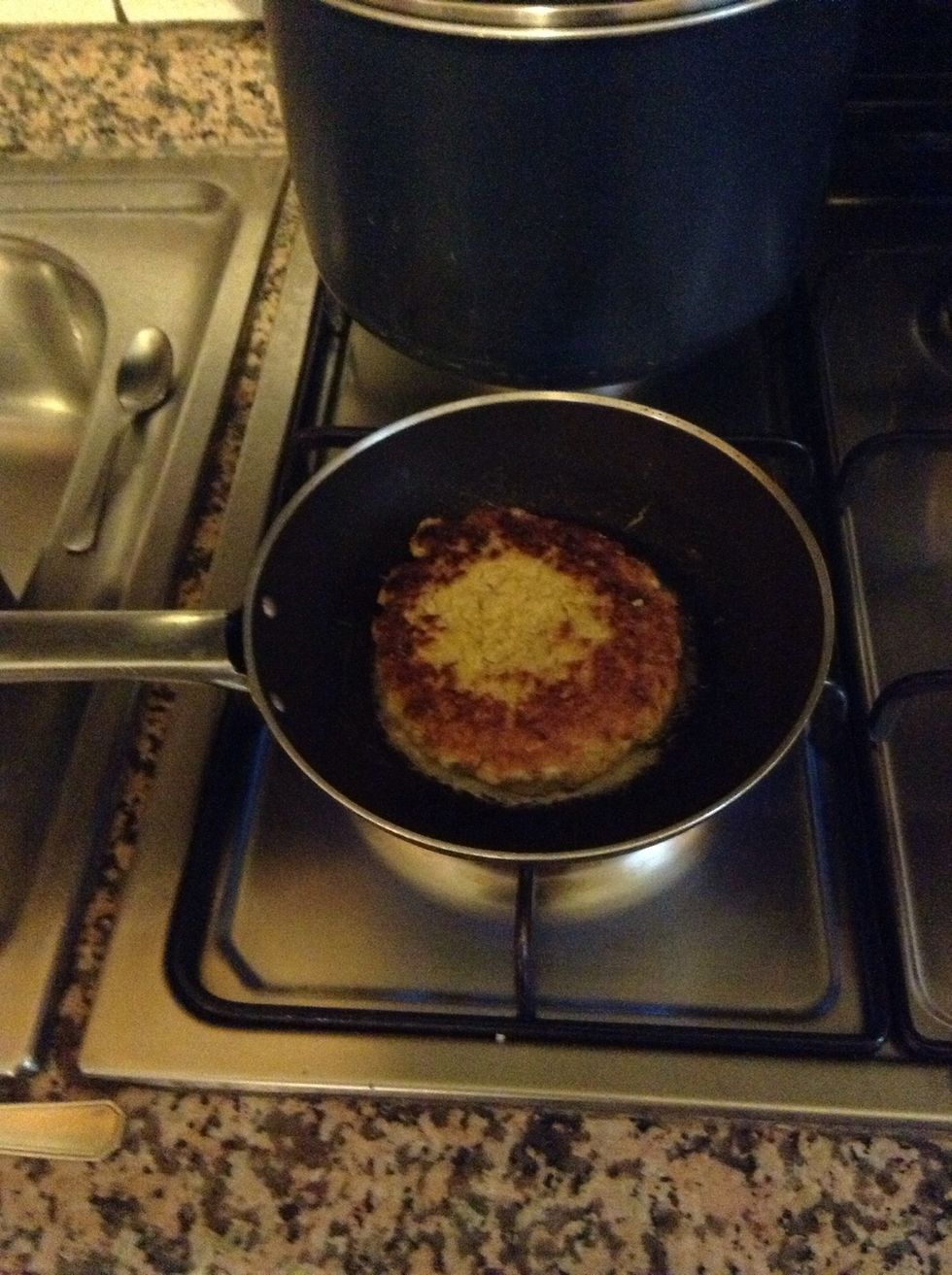 Cook the burger :) it will take a couple of minutes per side. Turn it just once.