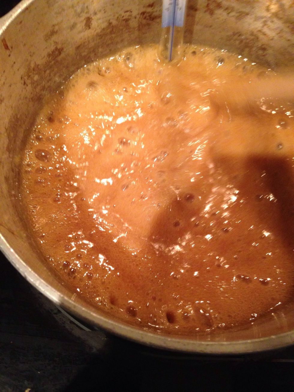 Cook the candy stiring occasionally until it reaches it's proper temperature: 240 degrees Fahrenheit.