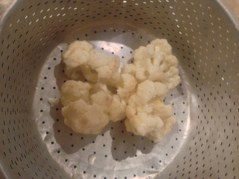 Cook the cauliflower over the steam .