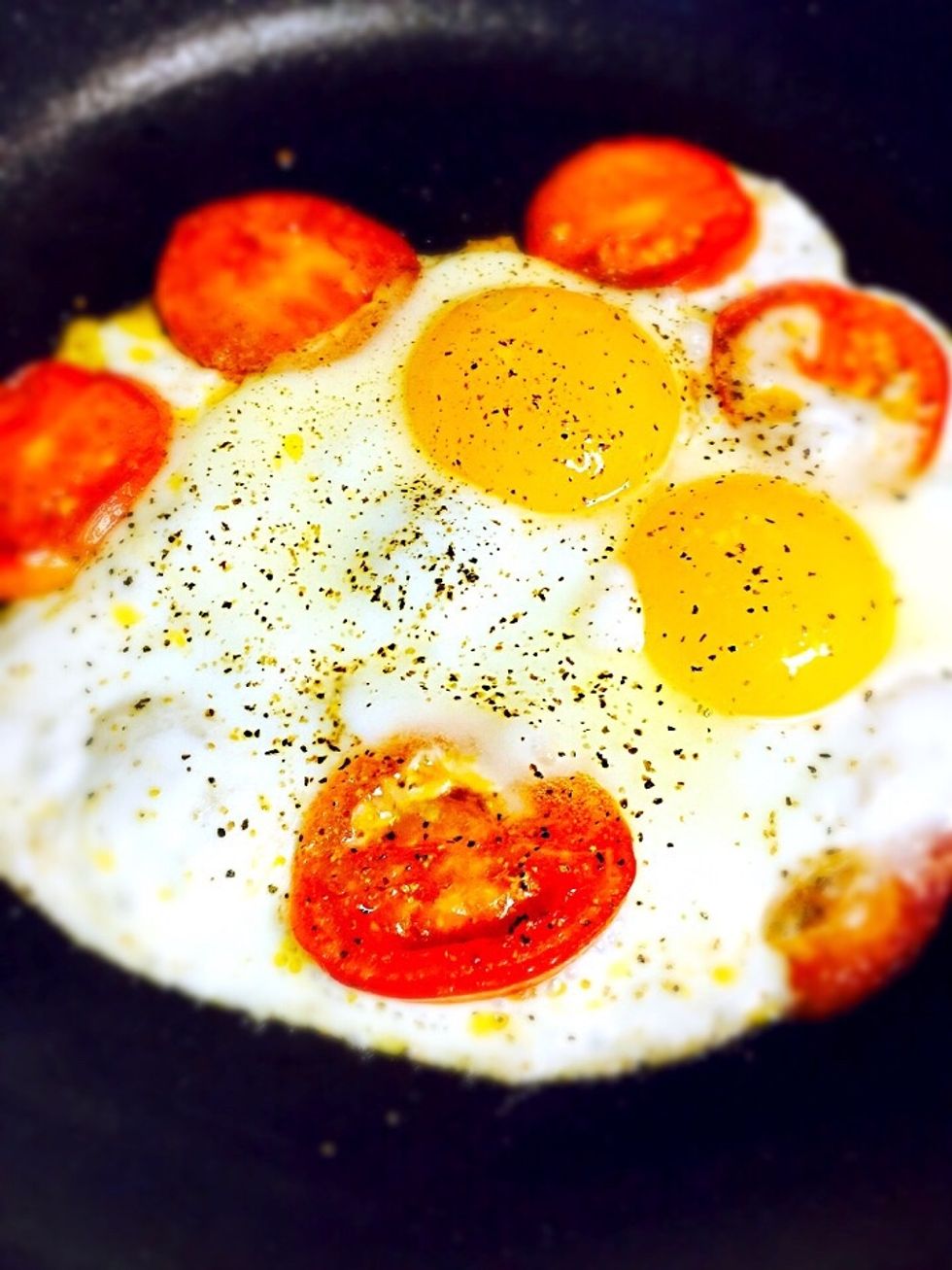 Cook the eggs on very low heat preventing it to burn before eggs are cooked. When it's almost done season with salt&pepper, sprinkle with grated cheese and garnish with dill