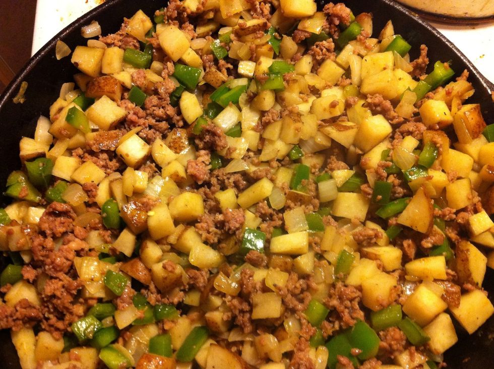 Cook the ground sausage in the pan breaking it up into pieces. Once the sausage is done drain it and then return it to the skillet and add the potato mixture.