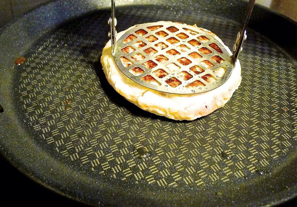 Cook the patty on each side for about 5 minutes, pressing them down as you cook until golden brown in colour.