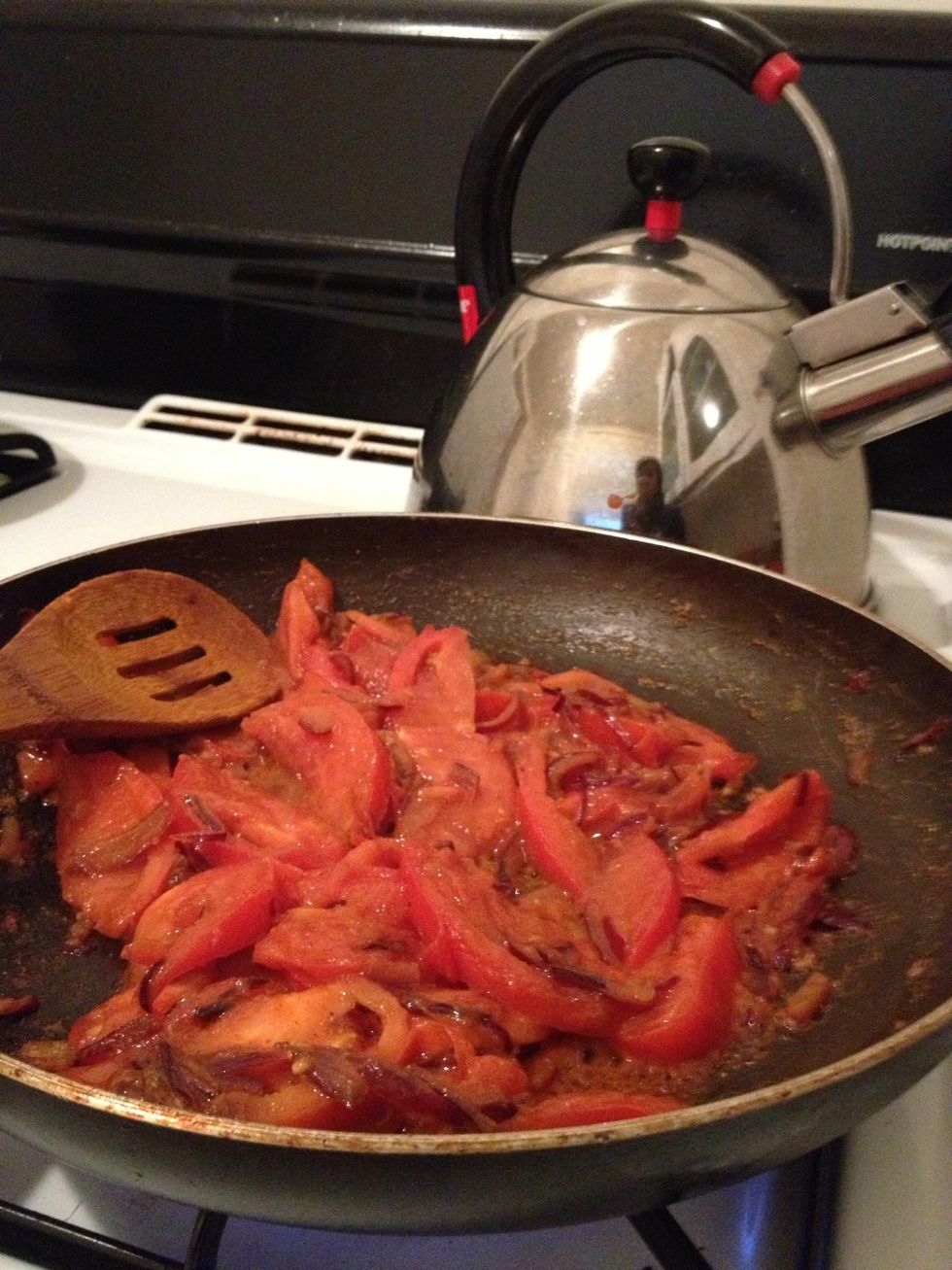 Cook the tomatoes and garlic paste with the onion and spices being cooked on the pan for 5 mins or till the tomatoes are soft and pasty