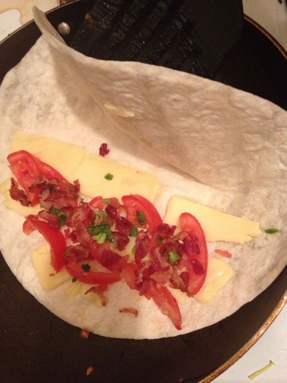 Cook the tortillas with these insides - Roma tomato slices, chopped bacon, and jalape\u00f1o till one side of the tortilla turns crispy brown!
