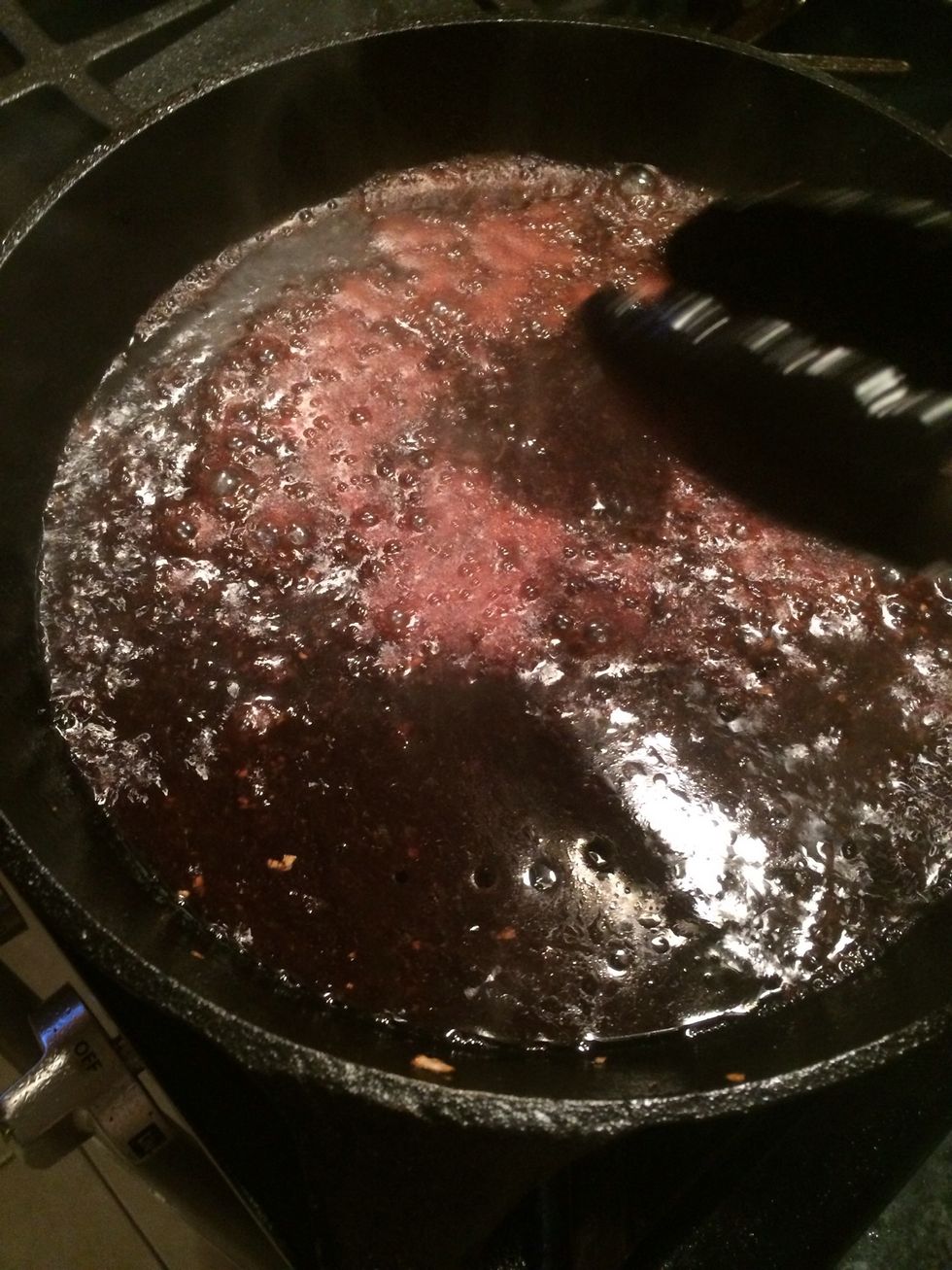 Cook the wine until it is reduced by half.