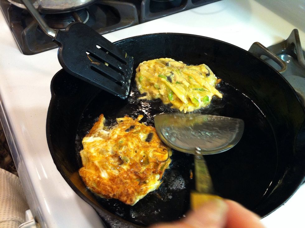 Cook till it's brown and crusty. It doesn't have to be fully cooked because it'll cook for longer in the gravy. To flip get two spatulas ready.
