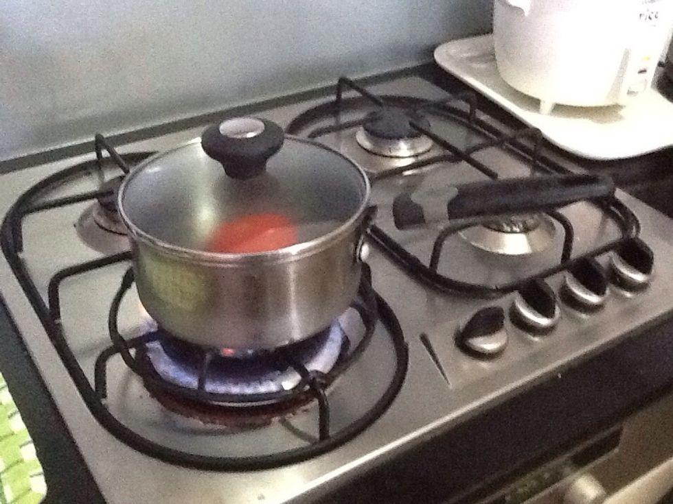 Cook tomatoes on high heat until the water boils. After it boils turn it off and let it sit there for a few minutes.