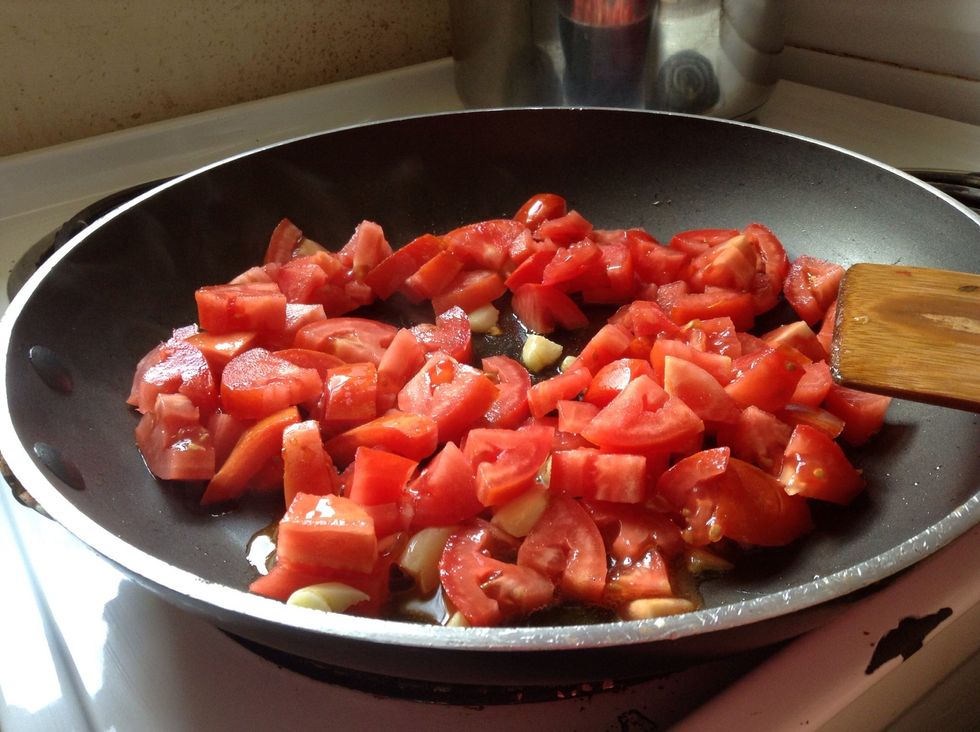 Cook tomatoes until they begin to soften
