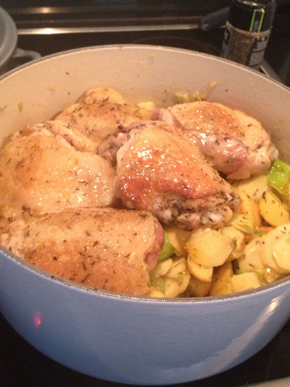 COOKING STEP: use the tongs to put the chicken thighs on top of the lightly cooked vegetables