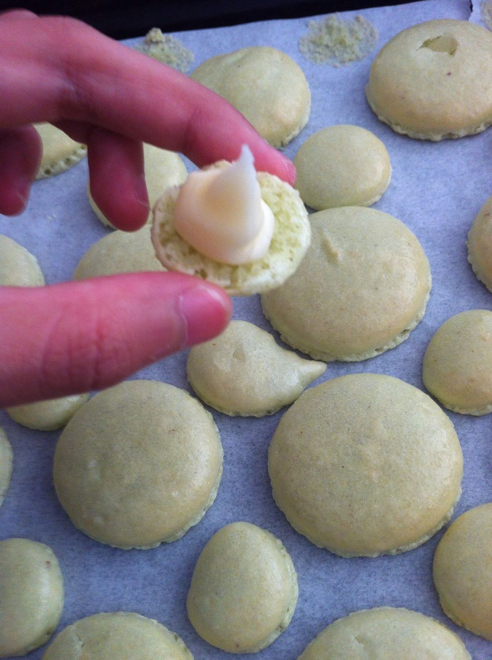 Cool macarons in tray for 5 minutes. Peel off paper when warm. When cooled COMPLETELY on a wire rack, pipe filling on. You can use buttercream, jam, Nutella or anything you want.