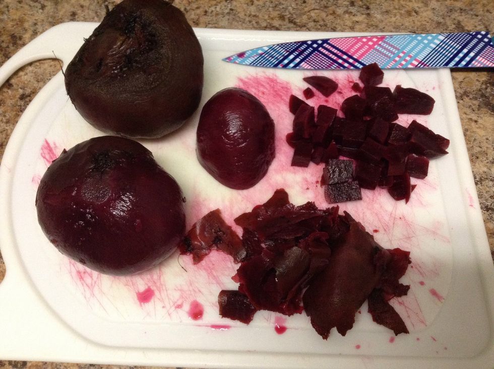 Cool the beets down under cold water then peel the skin with your fingers. Remove any remaining skin or dirt with a knife and dice the beets.