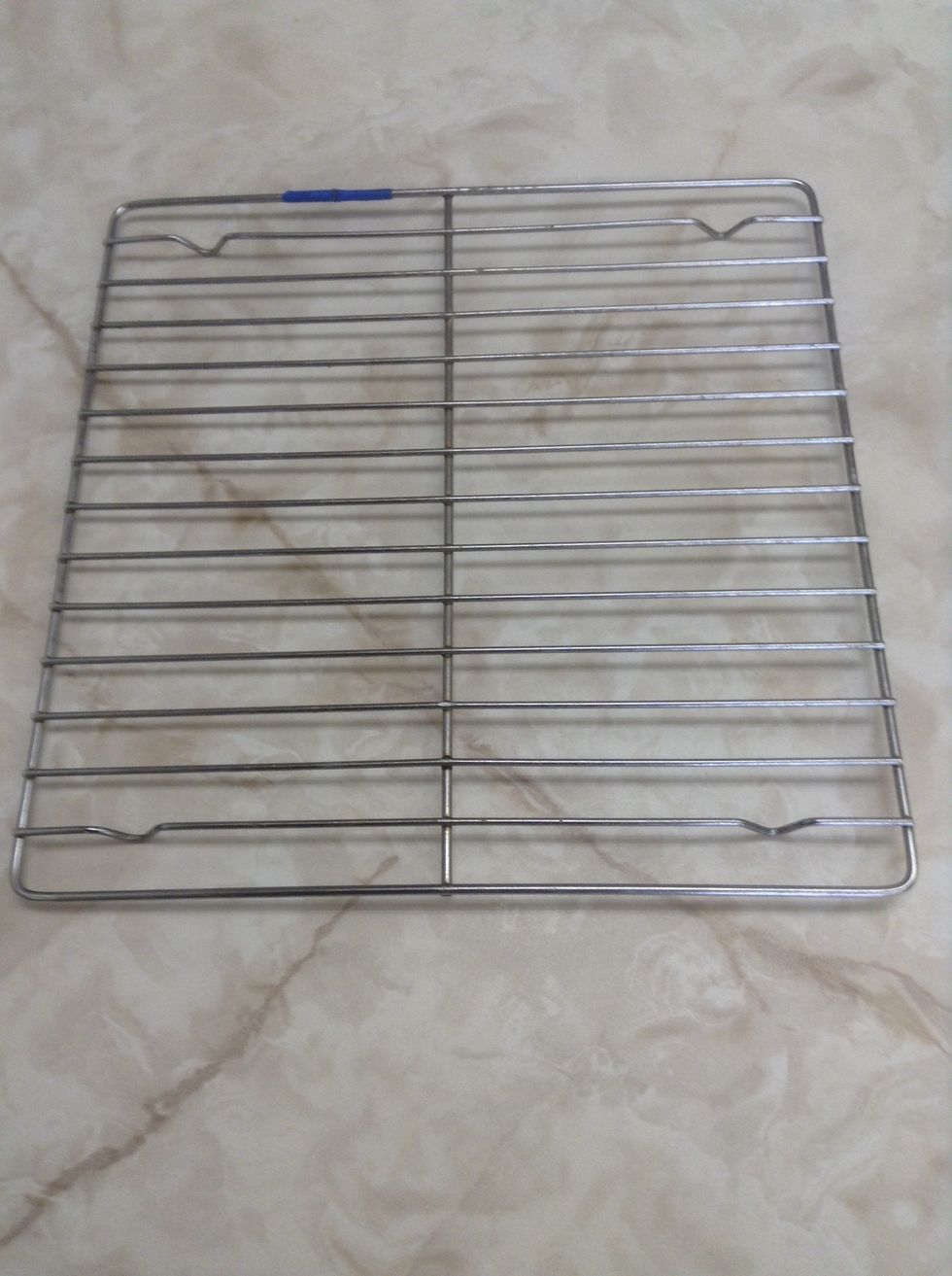 Cooling rack. You use it by putting hot pans on it. People who are too poor to have granite counters use these. I would use a cooling rack to put pans on it, but I have granite counters at home.