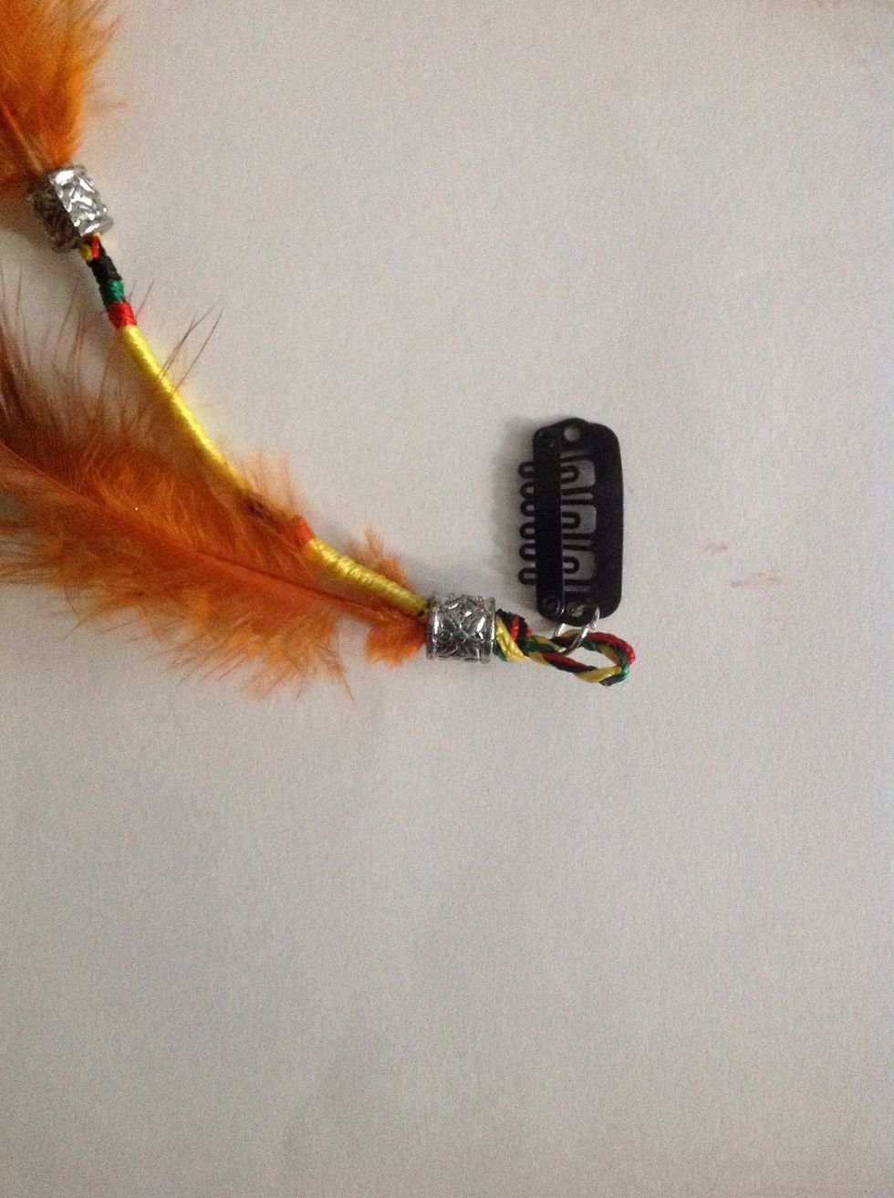 Cord attached to the clip using a jump ring. And feathers are tied to the cord using thread and the knot is covered with a silver bead.
