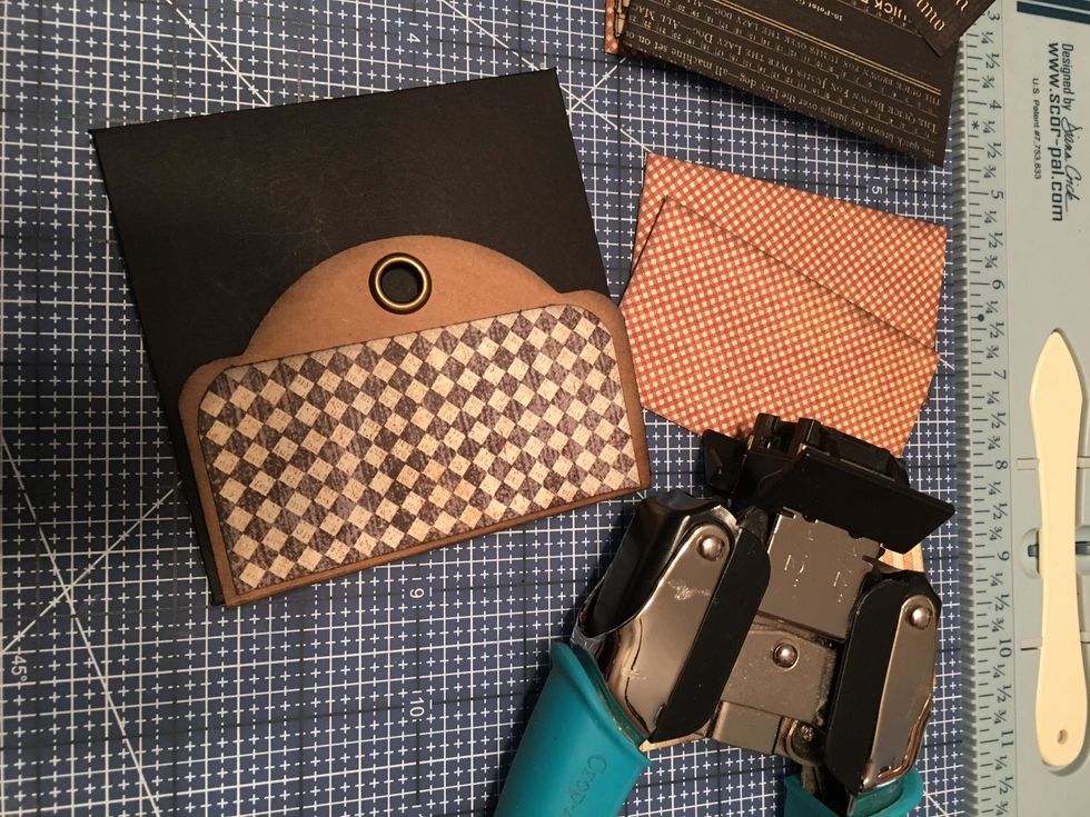 Corner round the patterned paper that attaches to the the flap of the tag as shown in this photo.