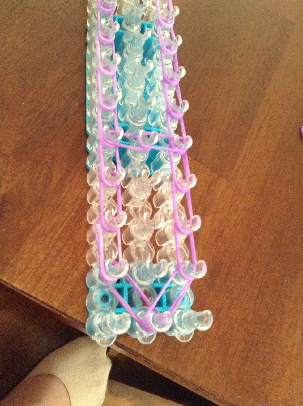 Count down 4 pegs on the left side. Go from there to the center peg and from the center peg to the right.