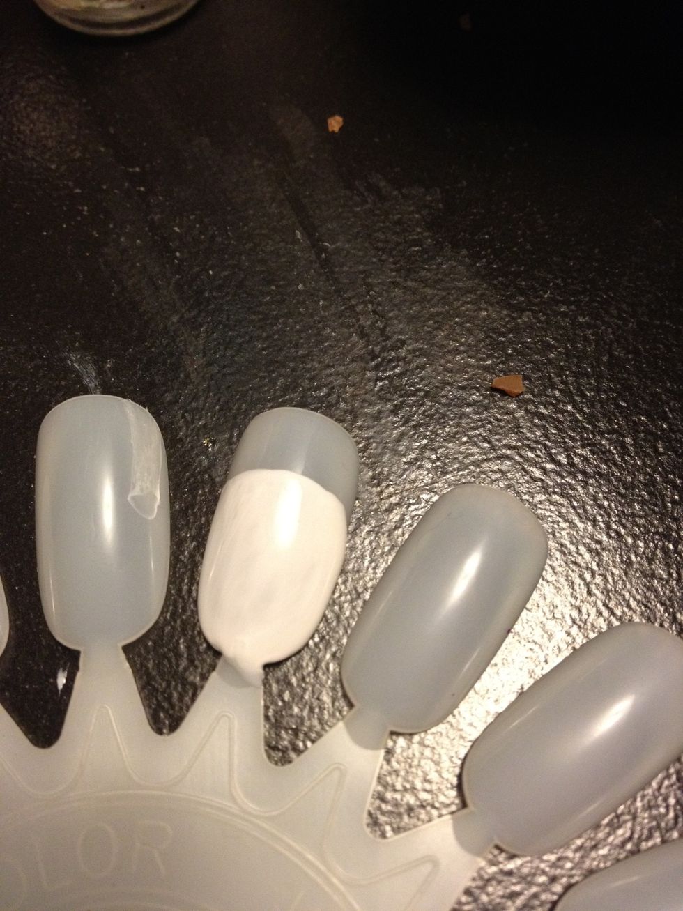 Cover 3/4 if your nail with a white polish, leaving the tip clear.