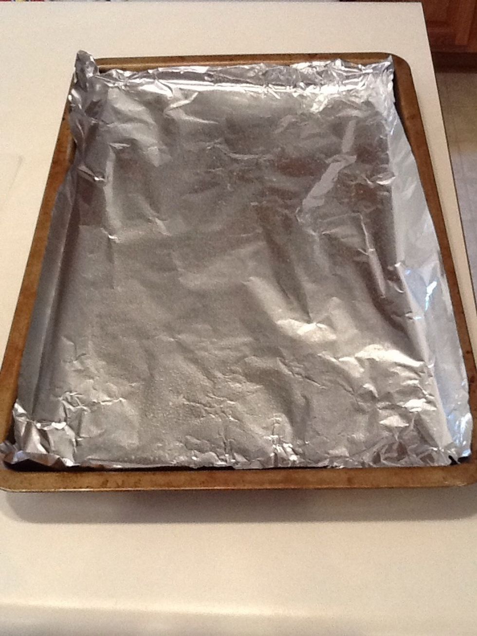 Cover a baking pan with aluminum foil and spread olive oil on top of the foil.
