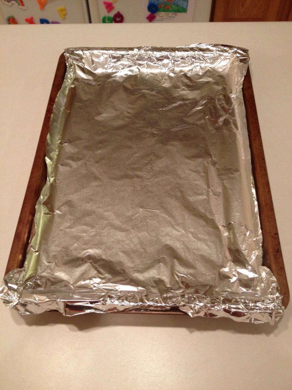 Cover a baking pan with aluminum foil. Make sure your pan has raised edges.
